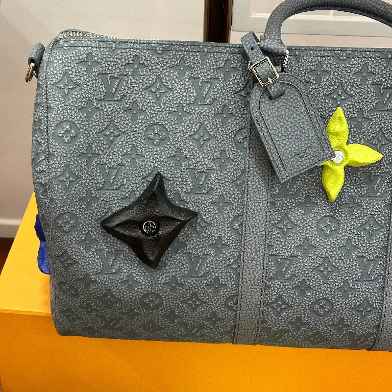 Louis Vuitton crossbody bags with a woven leather strap for textureLouis Vuitton - Sac Keepall